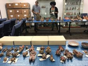Masters student Kendyll Gross curating artifacts.